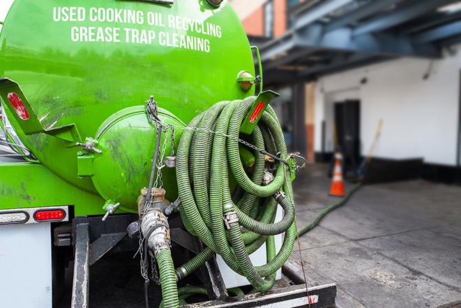 a grease trap pumping truck at a restaurant in Cashion